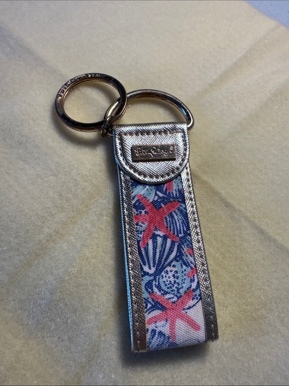 Lilly Pulitzer Silver Metallic Key Fob with Pink Starfish and Blue Shell Print